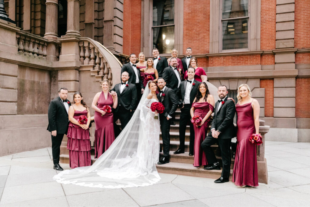 Full wedding party on a winter wedding day in Philadelphia on the stairs of the Union League