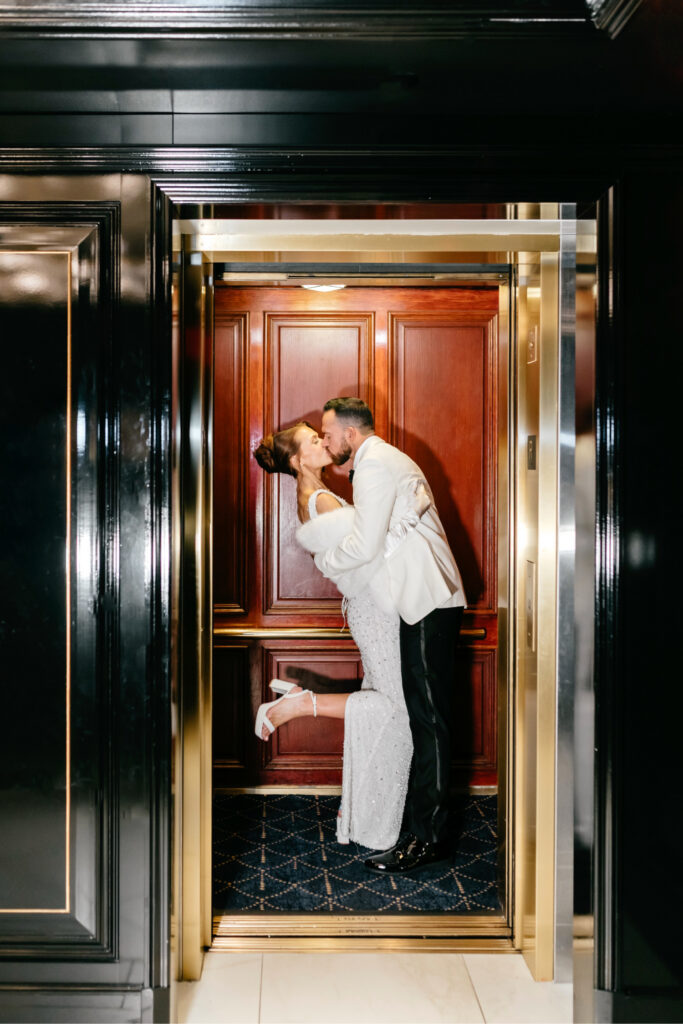 Philadelphia bride and groom kissing in the elevator of the union league on their winter wedding day