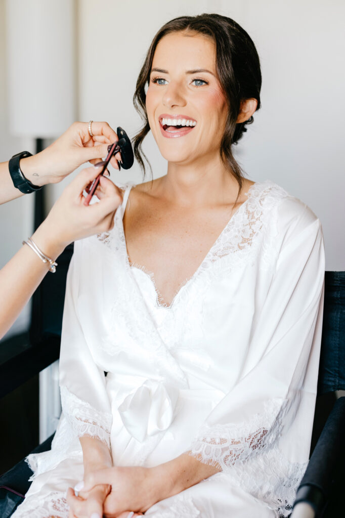 Philadelphia bride is getting her makeup done for her fall wedding day by Emily Wren Photography