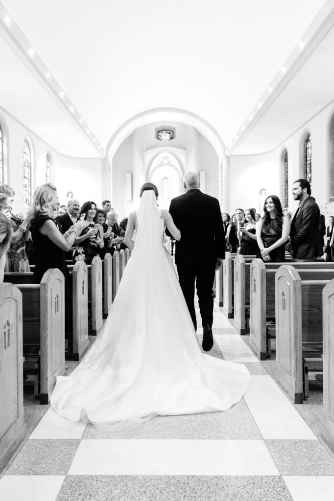 Philadelphia bride walking down the aisle during her wedding ceremony at St. Denis Catholic Church