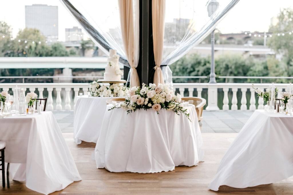 simplistic pink and white sweetheart table at fall wedding reception at Philadelphia Water Works