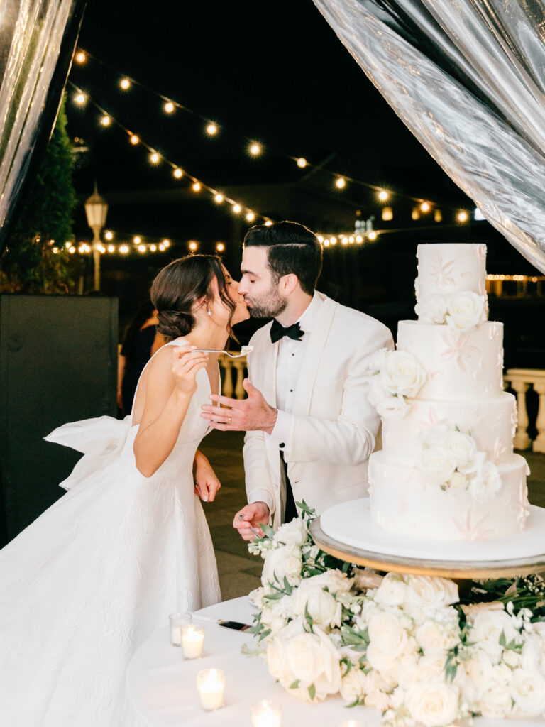 Philadelphia bride and groom cutting their four tier wedding cake at their luxurious Cescaphe wedding reception
