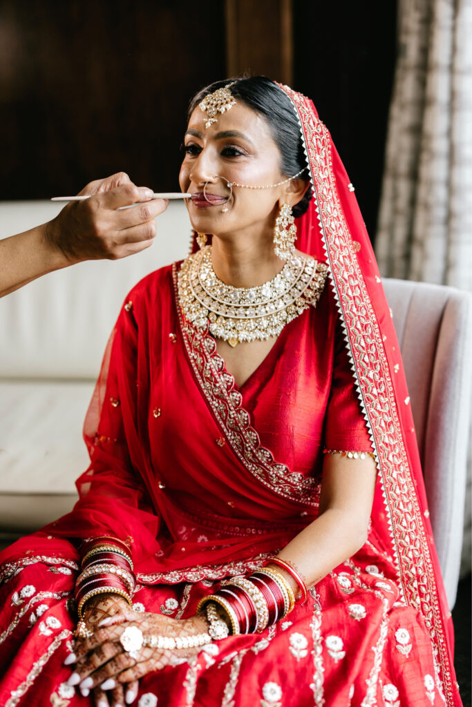 Philadelphia Hindu bride getting her makeup done for her Multicultural wedding day by Emily Wren Photography