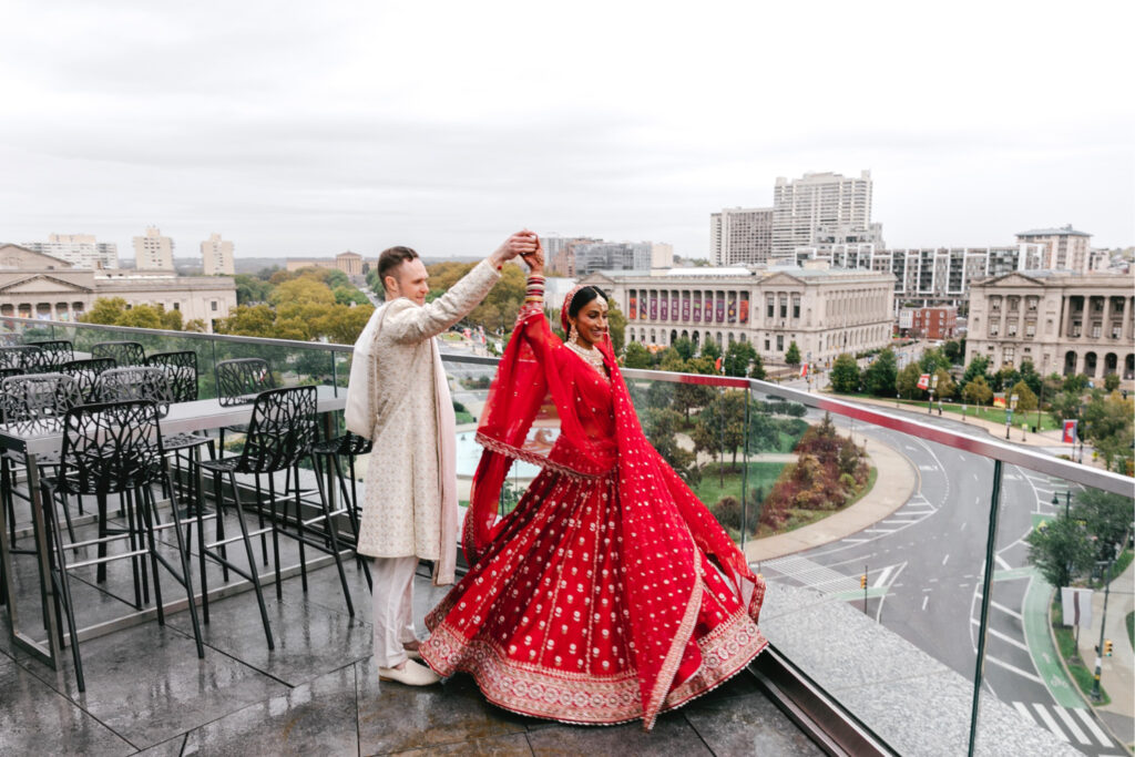 Philadelphia bride and groom portrait on Benjamin Franklin Parkway rooftop on fall wedding day by Emily Wren Photography