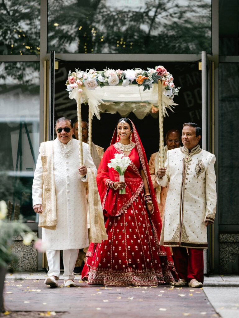 Philadelphia bride walking down the aisle at her outdoor Hindu wedding ceremony at the Logan Hotel