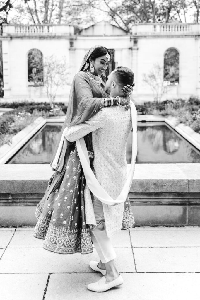 Philadelphia groom lifting and spinning his bride on their fall wedding day at the Rodin Museum