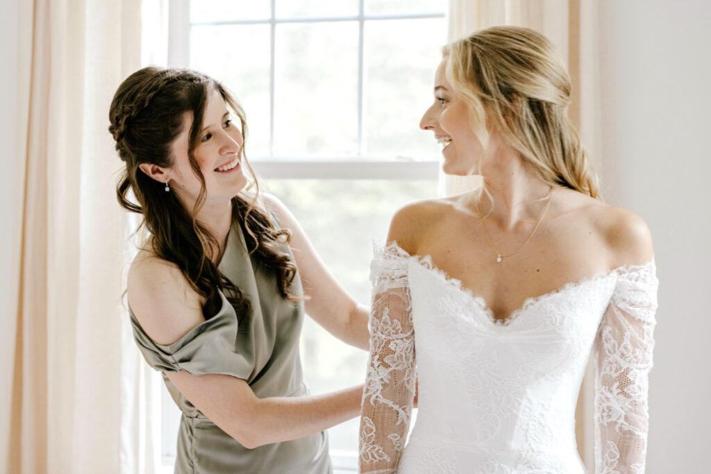 Philadelphia bride getting ready for her outdoor summer wedding at the Inn at Barley Sheaf with her maid of honor