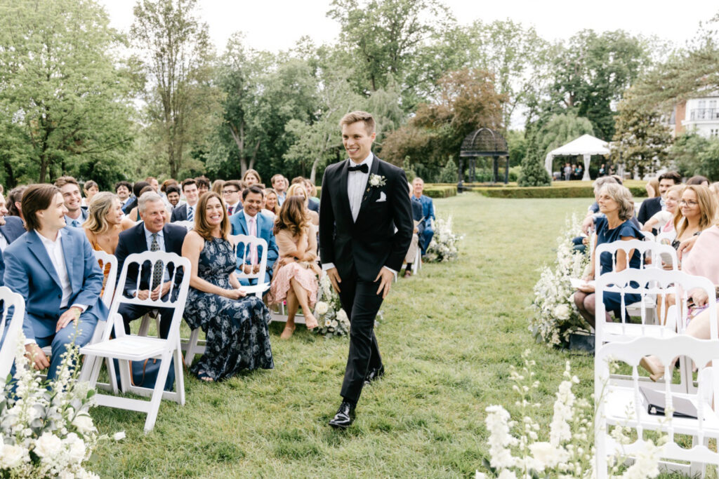 Philadelphia groom walking down the aisle at his outdoor spring wedding ceremony at the Inn at Barley Sheaf