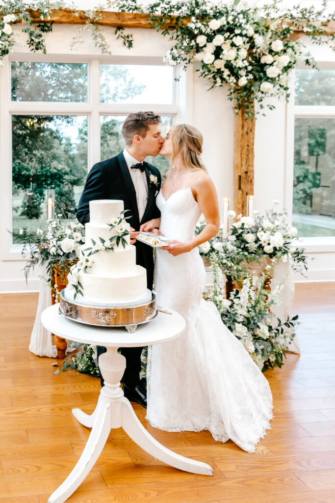 bride and groom cutting their four tier wedding at their Inn at Barley Sheaf wedding reception