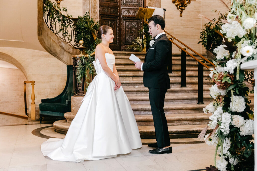 bride and groom private vow reading on their fall wedding day at luxurious Wilmington hotel, Hotel Du Pont