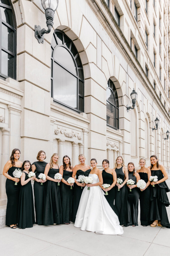 Delaware bride with her bridesmaids in black bridesmaid dresses on glamorous fall wedding day