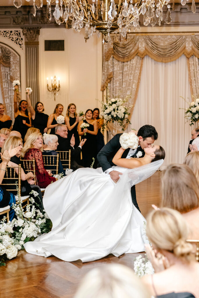 bride and groom exiting their luxurious all-white wedding ceremony at Hotel Du Pont in Wilmington, Delaware