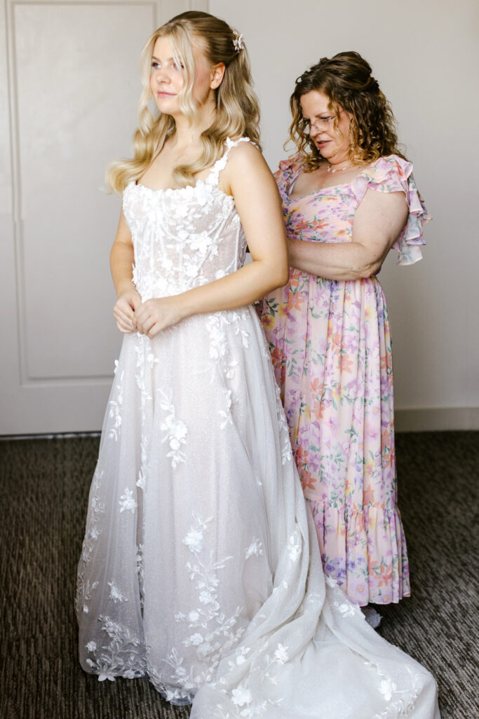 New Hampshire bride getting ready for her summer garden wedding with her mother