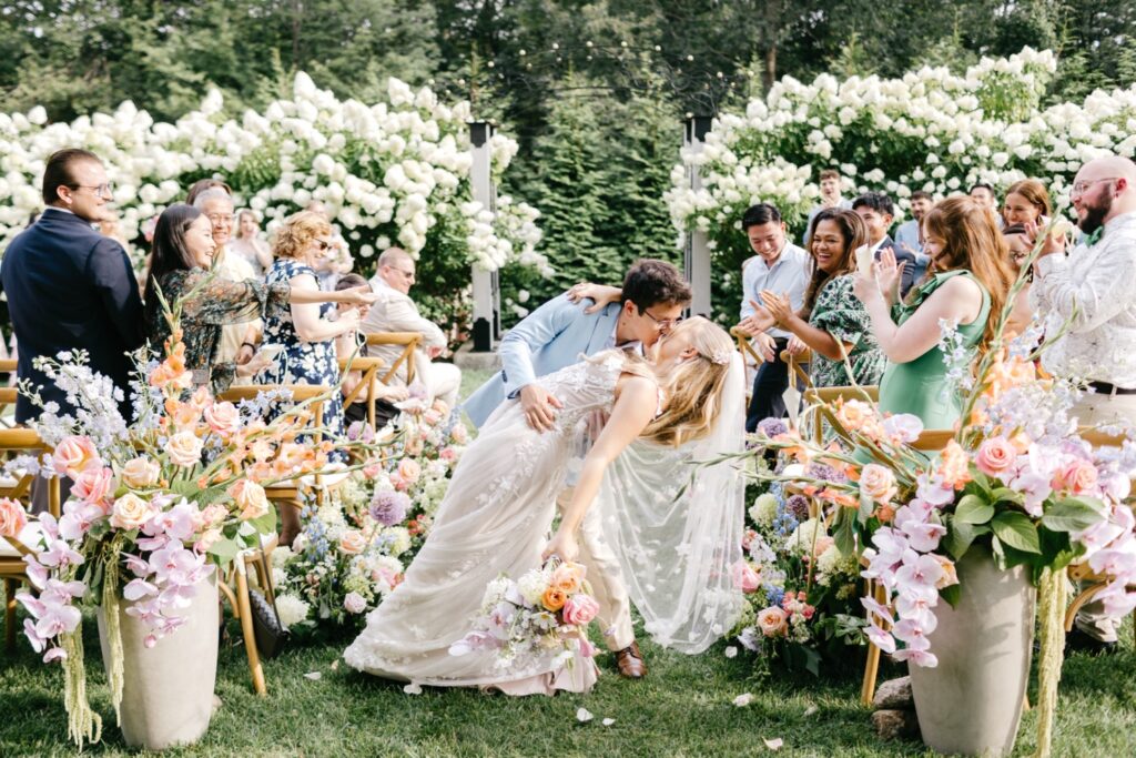 bride and groom exiting their outdoor summer garden wedding ceremony at Uncanoonuc Mountain