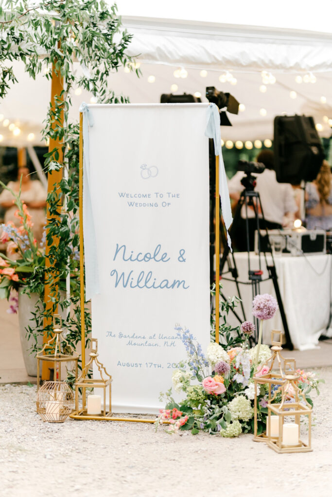 white and blue linen wedding reception welcome sign at Uncanoonuc Mountain