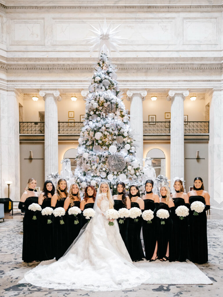 Philadelphia bride with her bridesmaids in black velvet bridesmaid dresses on her winter wedding day at the Ritz-Carlton