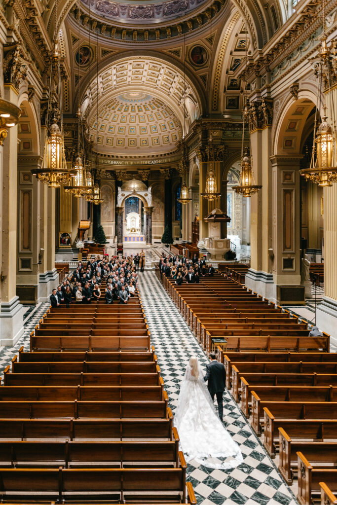 Philadelphia bride walking down the aisle at her church wedding ceremony at The Cathedral Basilica of Saints Peter and Paul