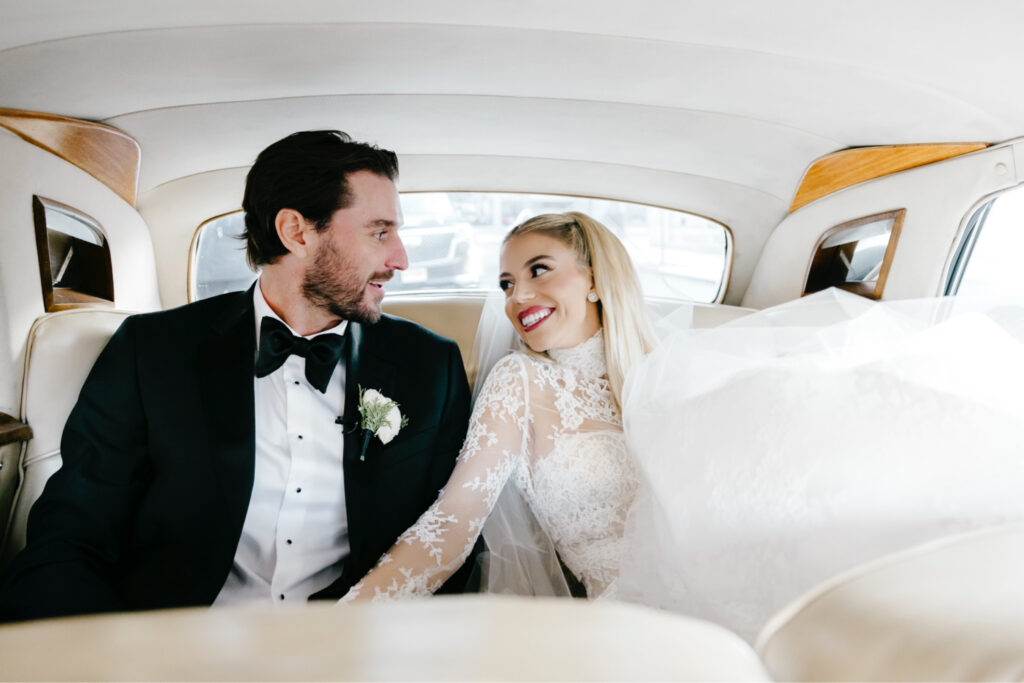 Philadelphia bride and groom riding in a vintage Rolls-Royce on their timeless winter wedding day