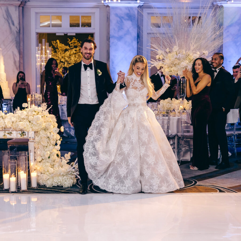 The Philadelphia bride and groom are entering their winter wedding reception at The Ritz-Carlton in Center City
