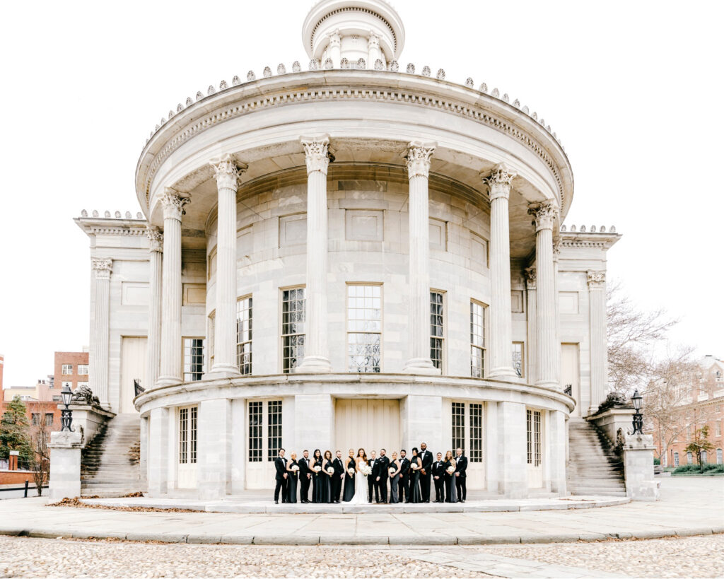 wedding day portrait of full wedding party at Merchant's Exchange in Center City Philadelphia by Emily Wren Photography