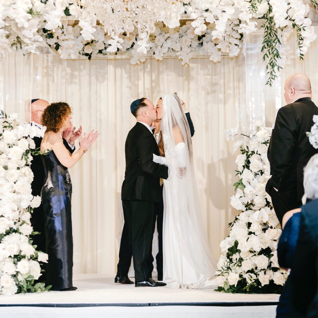 bride & groom's first kiss at their modern Westin Hotel Philadelphia wedding ceremony by Emily Wren Photography