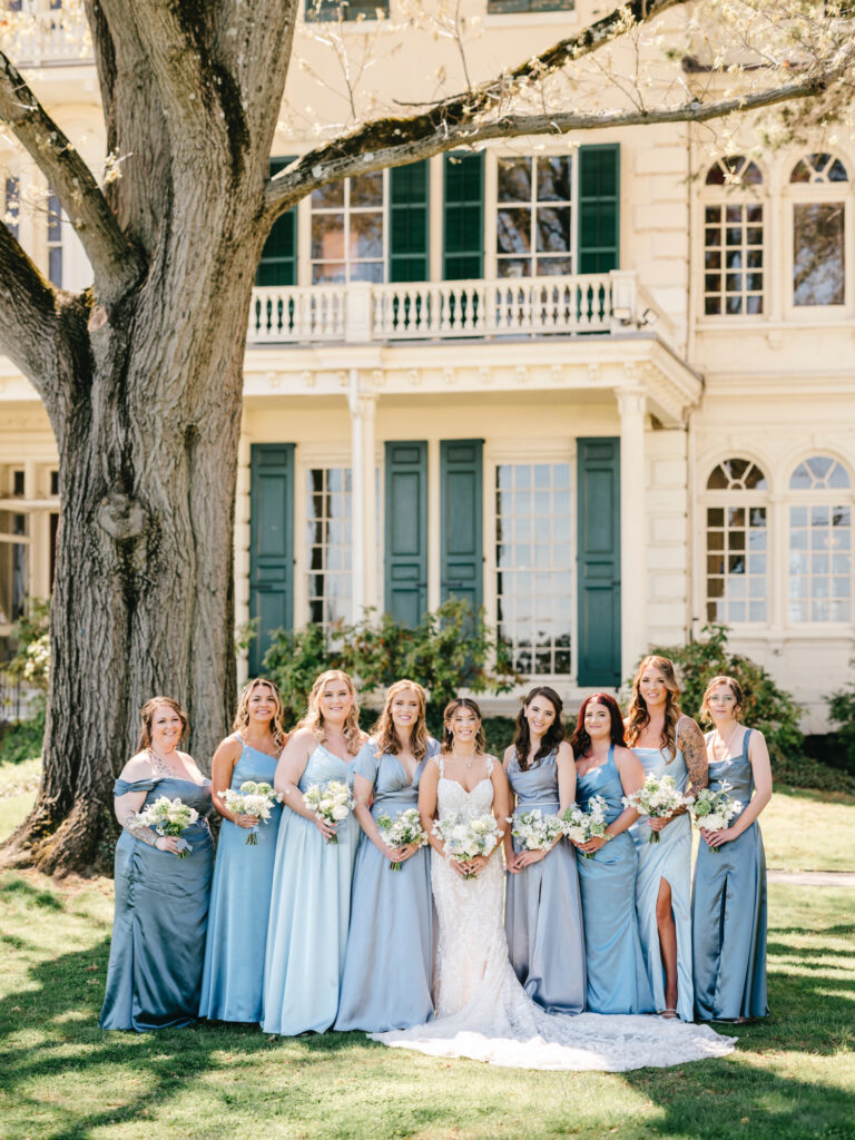 Philadelphia bride with her bridesmaids in coordinating blue bridesmaid dresses at Glen Foerd