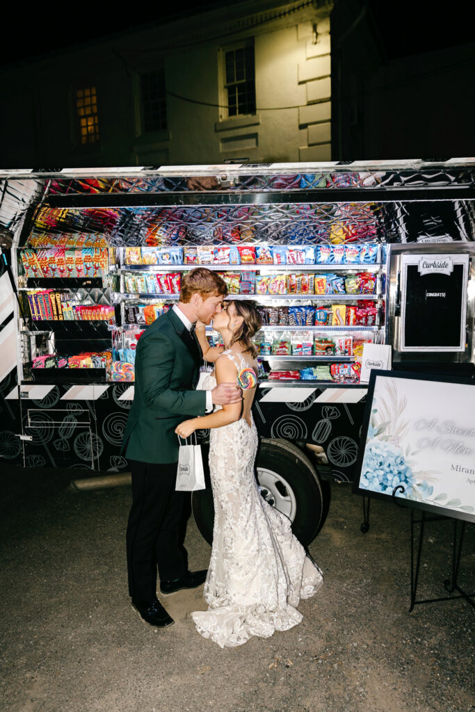Philadelphia bride and groom at their fun wedding reception at Glen Foerd, in front of a candy food truck by Emily Wren Photography