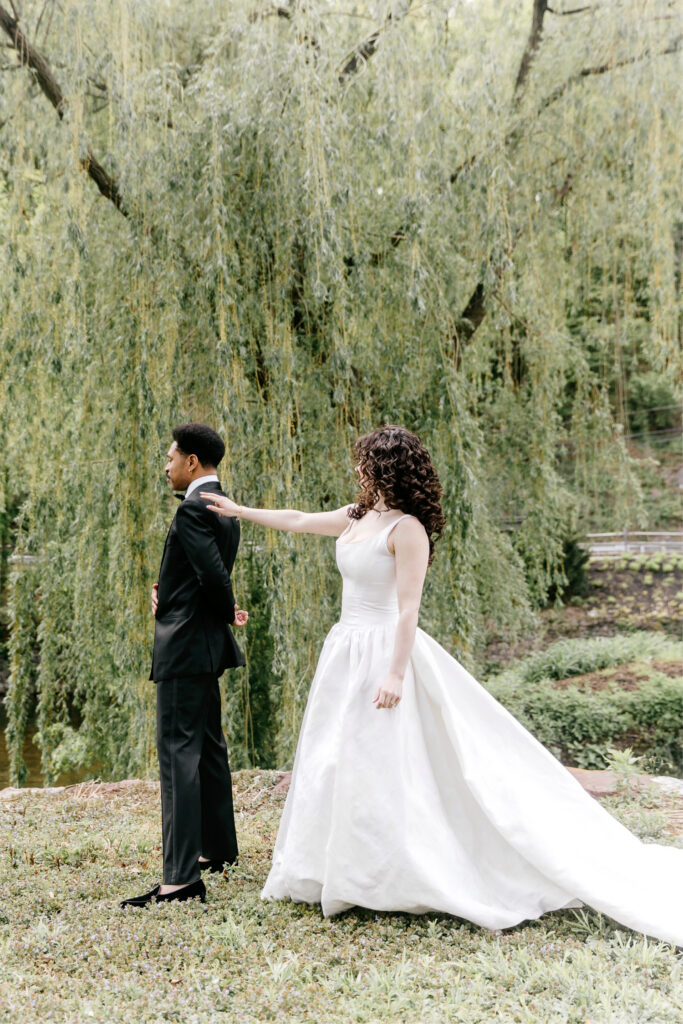 bride and groom's first look in front of a whimsical willow tree in New Hope, Pennsylvania
