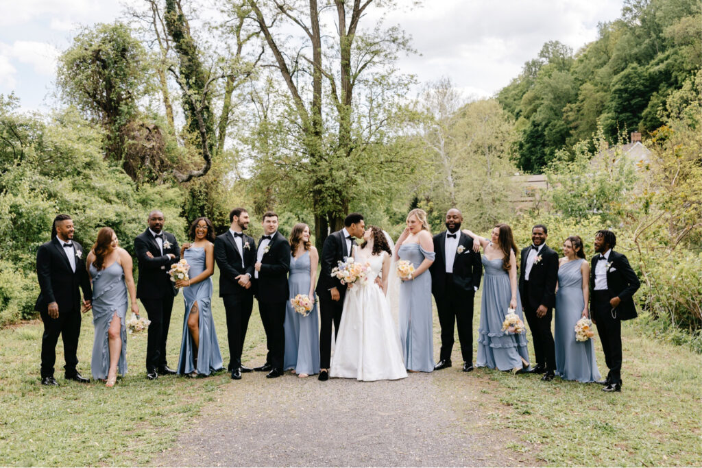 Philadelphia bride and groom with their full wedding party on their spring wedding day at River House at Odette's by Emily Wren Photography