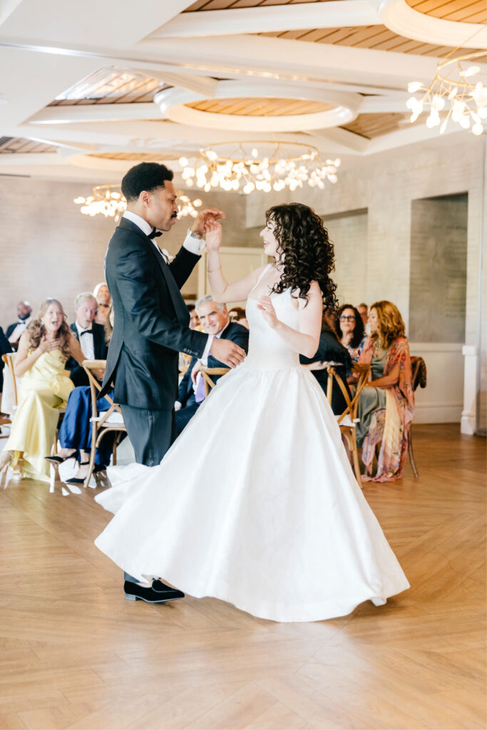 bride and groom's first dance during their spring wedding reception at River House at Odeette's