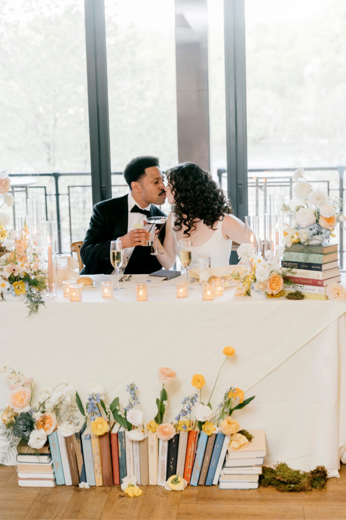 Philadelphia bride and groom at their whimsical sweetheart table by Emily Wren Photography
