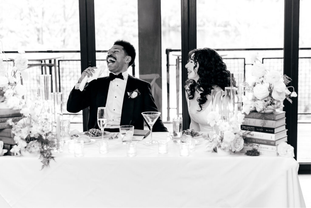 bride and groom during wedding party speeches at their River House at Odette's wedding reception by Emily Wren Photography