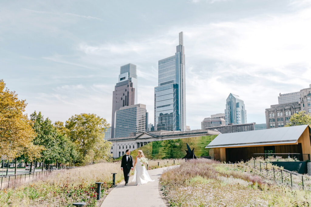 Calder Gardens wedding portraits in front of the Philadelphia city skyline by elegant wedding photographer Emily Wren Photography