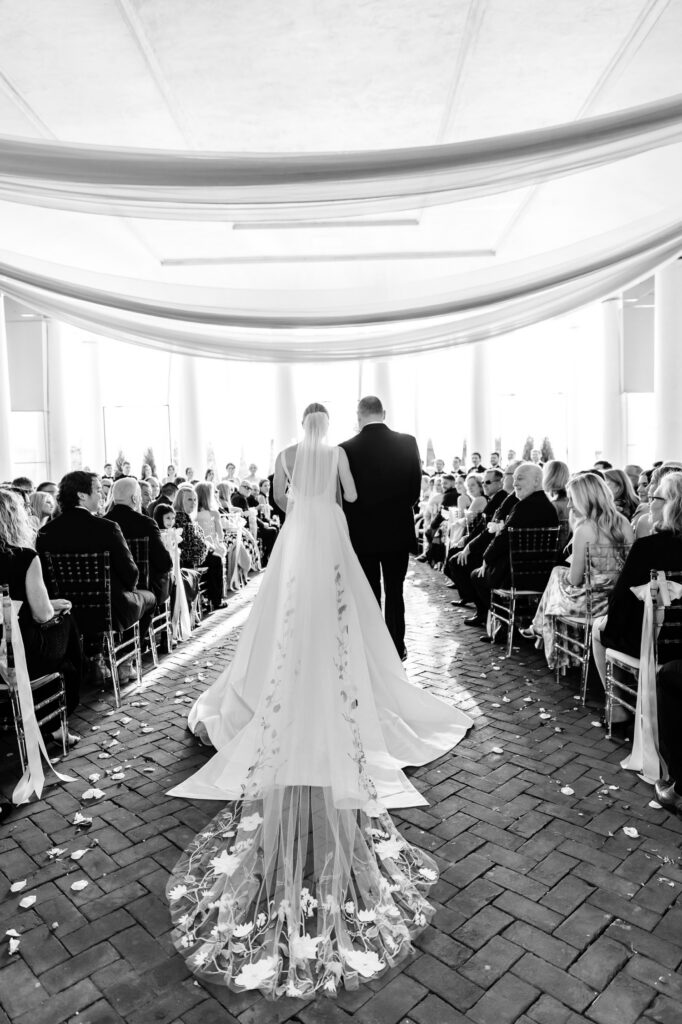 Philadelphia bride walking down the aisle at her Cescaphe wedding ceremony at Water Works in Fairmount