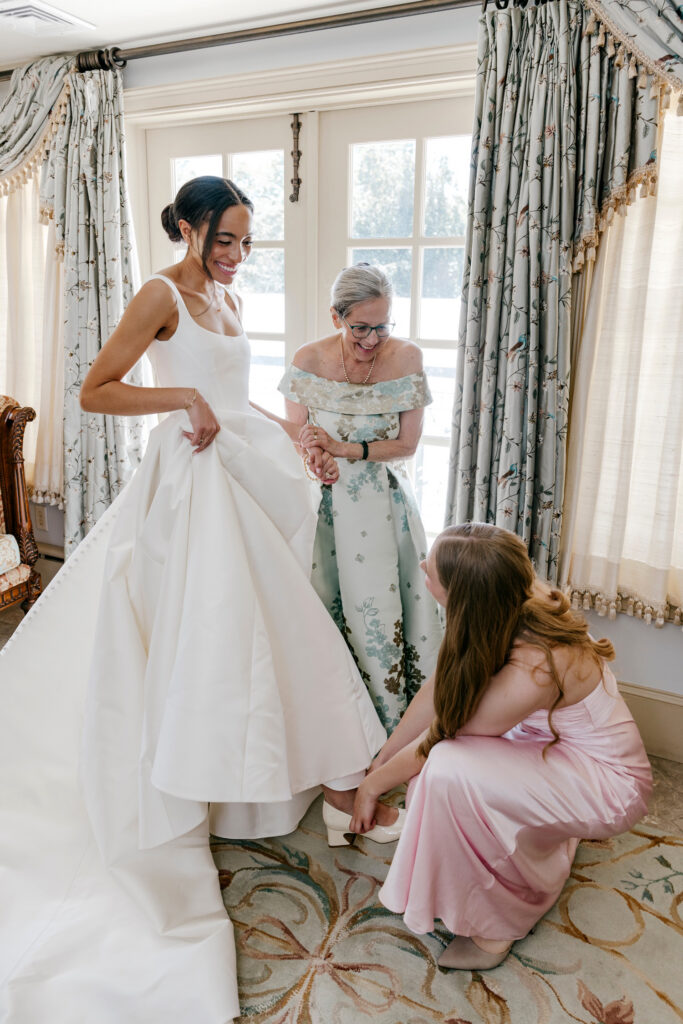 Philadelphia bride getting ready for her summer garden wedding at the Inn at Barley Shead with her mother and maid of honor