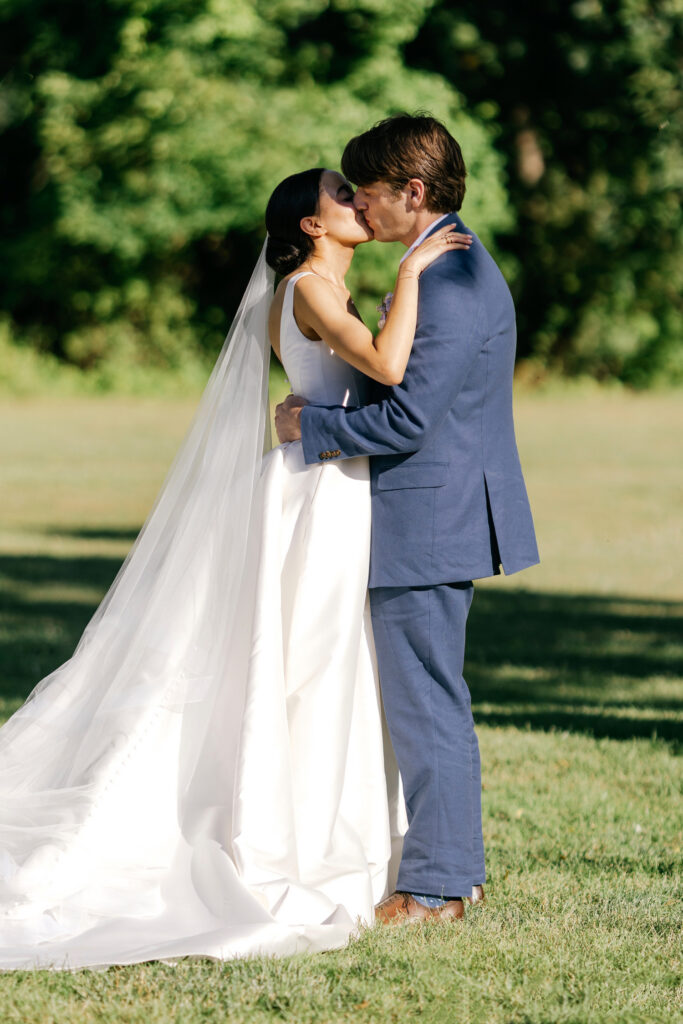 Philadelphia bride & groom's first kiss at their outdoor summer wedding ceremony at The Inn at Barley Sheaf