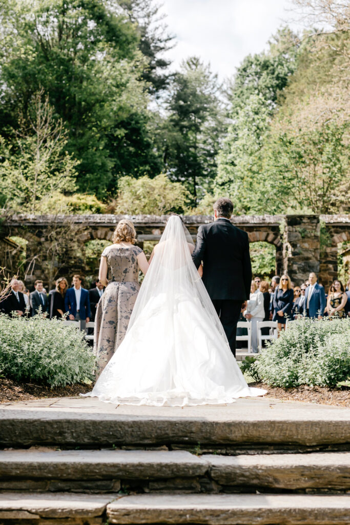 Philadelphia bride walking down the aisle at her outdoor wedding ceremony at Parque Ridley Creek
