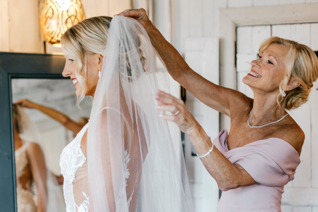 Philadelphia bride getting ready for her summer Terrain garden wedding with her mother