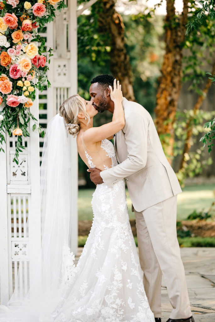 bride and groom's first kiss at their outdoor Terrain at Styer's wedding ceremony
