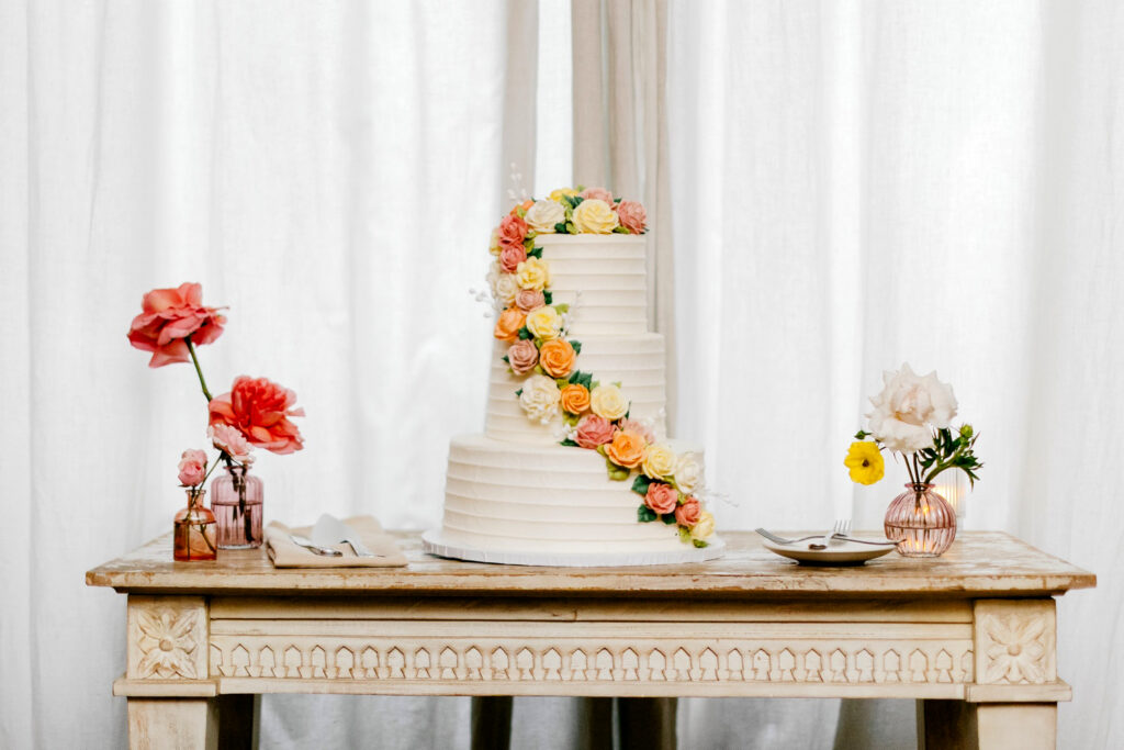 three tier, vibrant floral wedding cake for summer garden wedding by Philadelphia wedding photographer Emily Wren Photography